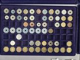 a purple box filled with lots of different types of coins