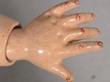 a toy hand that has writing on the fingers of it