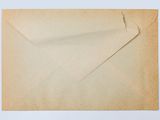 a brown envelope with a piece of paper sticking out of it
