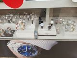 a display of watches in a store with a red apple in the background