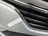 a close up of a car ' s grille with a sticker on it