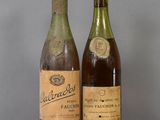two bottles of wine sitting on a table next to each other