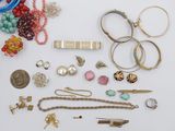 many different types of jewelry on a white surface