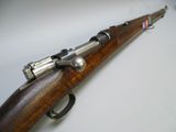 a close up of a rifle on a white surface