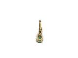 a gold and emerald pendant on a white background