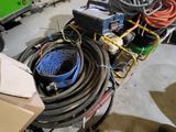 a pile of hoses and other equipment in a garage