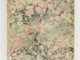 an old book with pink and green marbled paper on it