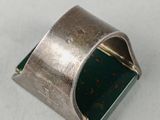 an image of a silver ring on a white surface