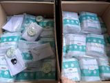 two boxes of baby diapers sitting on top of a table