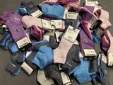 a pile of socks with tags on them on a table