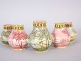 three vases with different designs on them sitting on a table