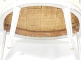 a white chair with a wicker back and a wooden seat
