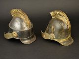 pair of silver and gold helmets on a black background
