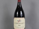 an image of a bottle of red wine sitting on top of a table