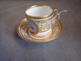 a cup and saucer sitting on a table