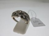 a close up of a ring on a white surface with a price tag