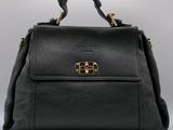 a black leather handbag with gold hardware on the handle