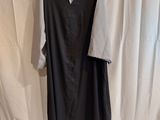an image of a black and white dress on a mannequin stand