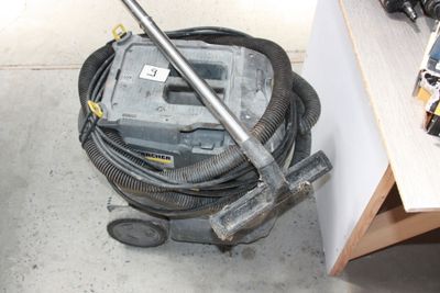 a vacuum that is sitting on the floor next to a table