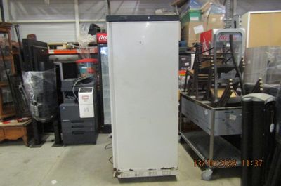 a refrigerator that is sitting in the middle of a room