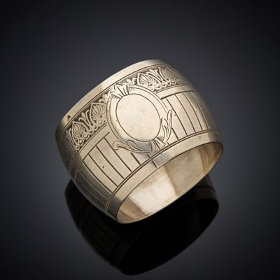 a close up of a silver ring on a black surface