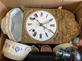 a box with a clock inside of it that has many items inside of it