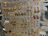 a lot of earrings on display in a display case