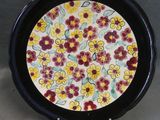 a close up of a plate with flowers on it on a table