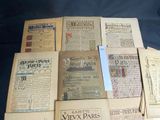 a pile of old newspapers sitting on top of a table