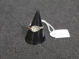 a close up of a ring on a black cone with a price tag