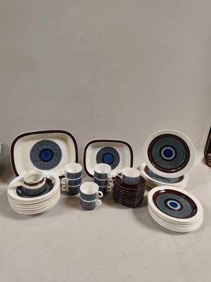 many different types of dishes and cups on the table