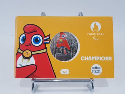 a card with a picture of a red bird holding a gold medal