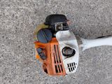 an overhead view of a chainsaw on the ground