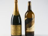 two bottles of champagne sitting next to each other on a white surface