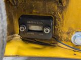 a close up view of the front end of a yellow vehicle