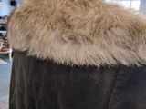 a coat with a fur collar on a mannequin mannequin mannequin mannequin mannequin mannequin mannequin mann