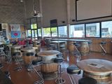 tables and stools are lined up in a large room with lots of windows