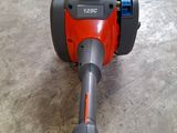 an orange and gray blower sitting on top of a cement floor