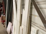 many pieces of wood leaning against a wall in a garage