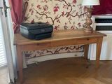 a wooden table with a printer on top of it