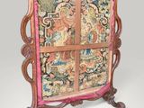 an old wooden frame with a tapestry on top of it