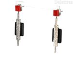 pair of black and white earrings with red stones and diamonds
