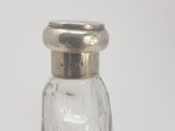 a glass salt and pepper shaker with a silver lid