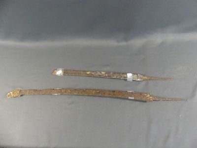pair of old metal tools sitting on top of a table