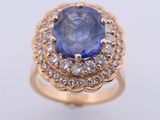 a close up of a blue sapphire and diamond ring on a white background