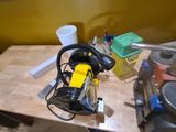 a workbench with tools on it in a room with yellow walls