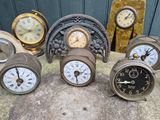 many different clocks sitting on the ground next to each other