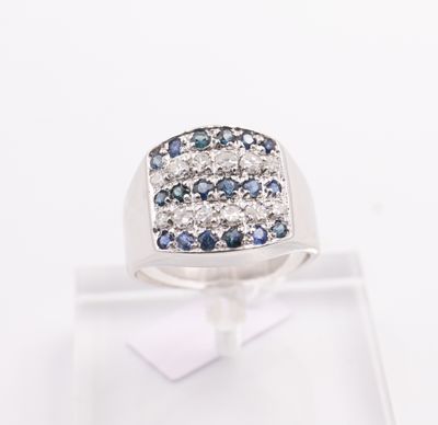 a close up of a ring with blue and white diamonds