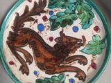 a plate with a picture of a squirrel on it
