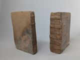 two pieces of stone are sitting next to each other on a white surface